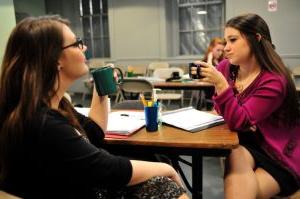 two women chat over coffee in the play thugs