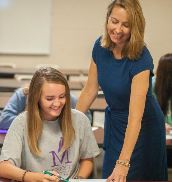 Female instructor assisting student